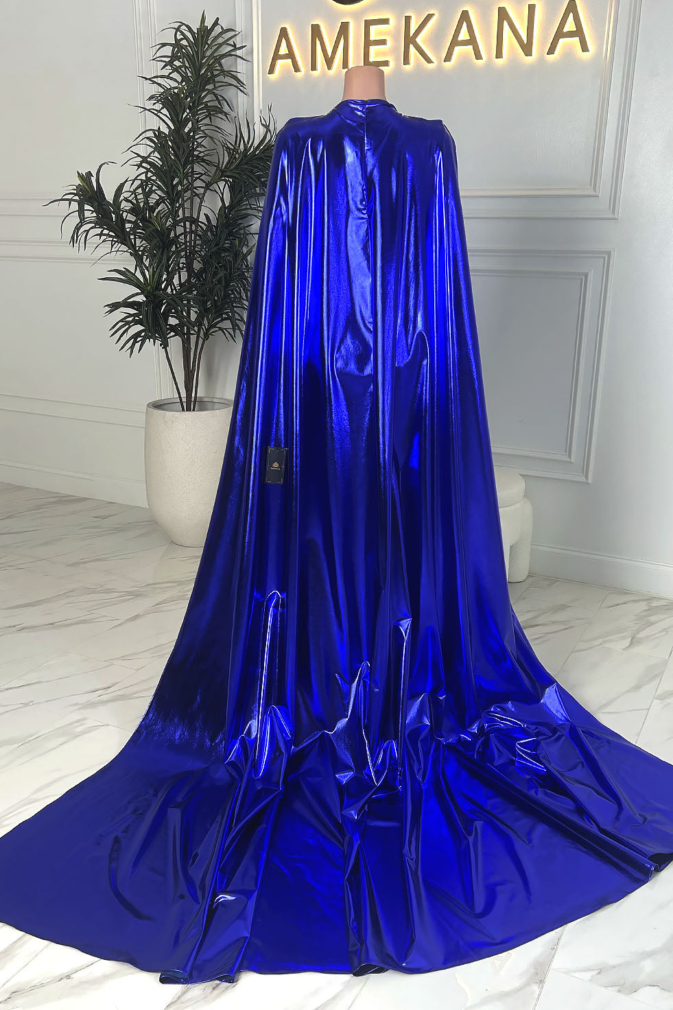 Full back view of electric blue floor length cape with dramatic train, displayed on mannequin.