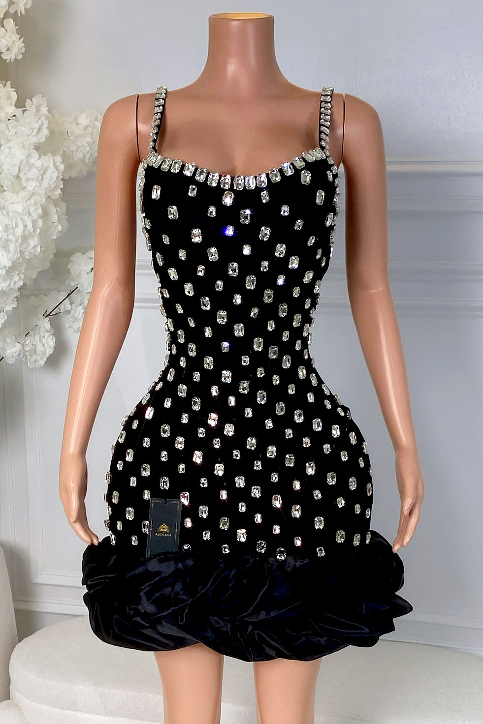 Front view of black rhinestone mini dress with square neckline, rhinestone straps, and bubble hem