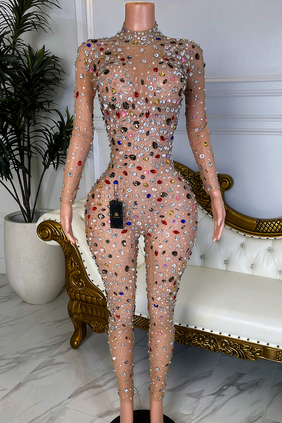 Front view of nude mesh long sleeve jumpsuit covered in multicolor rhinestones and crystals, bodycon fit, high neck, Amekana