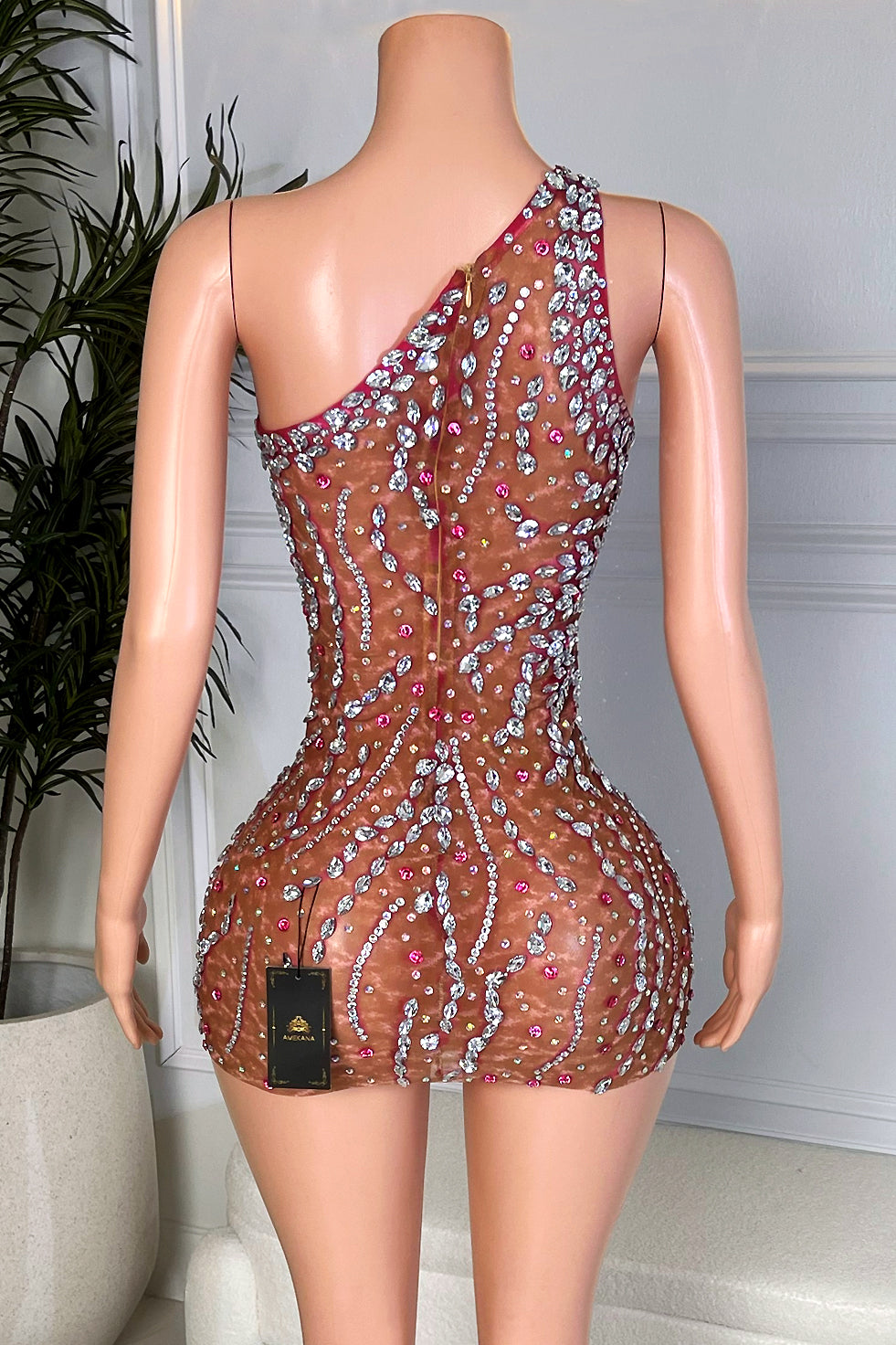 Back view asymmetrical nude brown rhinestone mini dress with swirl crystal embellishment and hidden zipper closure, rear view