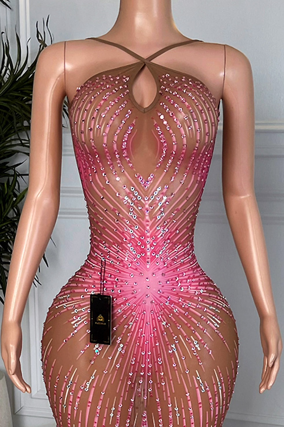 Close up of Amara Pink Feather Maxi Dress bodice with crisscross straps, keyhole neckline, and radiating pink rhinestone pattern