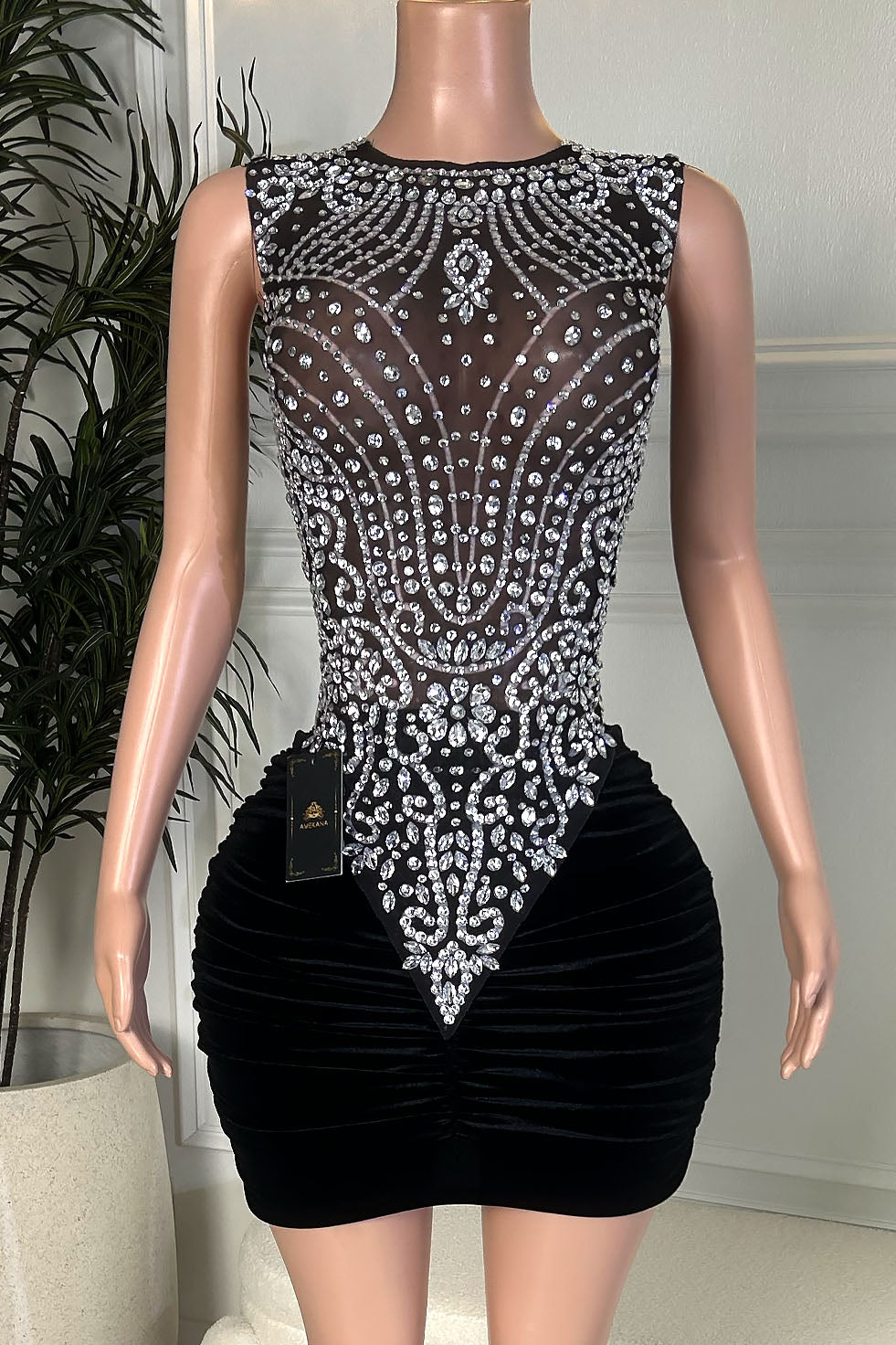 Black velvet mini dress with an ornate silver rhinestone bodice, sleeveless high neckline, fitted ruched skirt, front view.