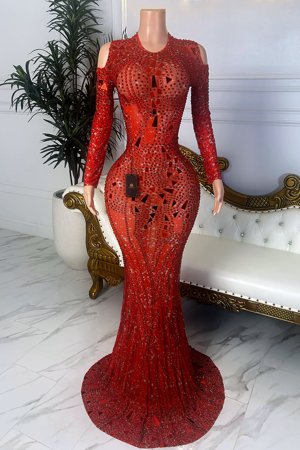 Front view of a red crystal illusion dress with rhinestone embellishments, mirror-style accents, long sleeves, cold-shoulder cutouts, and mermaid-style hem