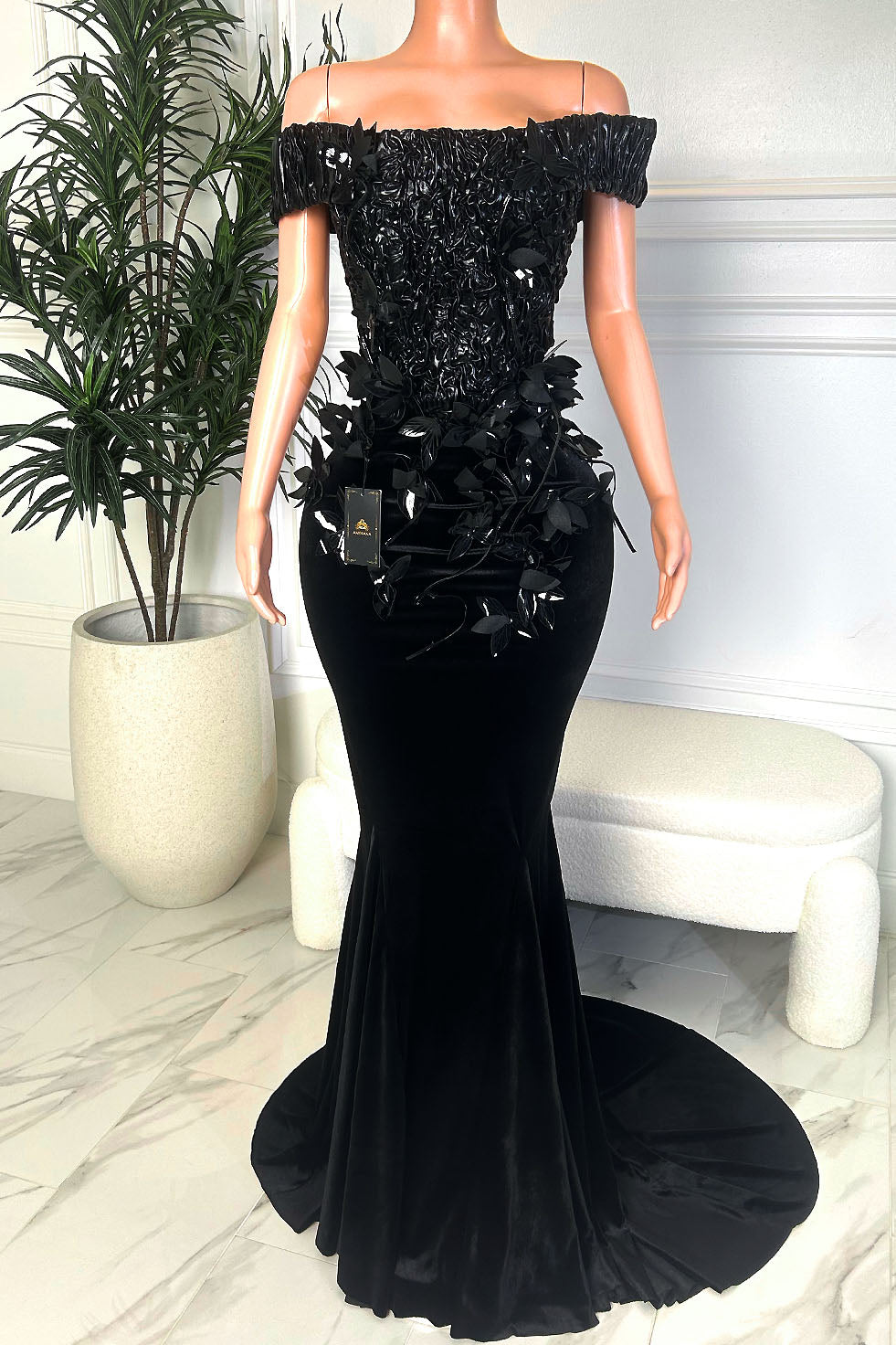 Black off-shoulder velvet mermaid dress with textured bodice, floral appliqué , and a long sweeping train