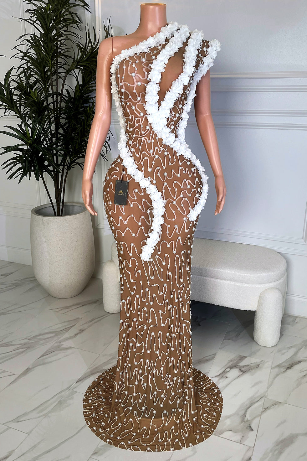 White flower asymmetrical nude illusion maxi gown with pearl embellishments and fitted bodycon silhouette, front view by Amekana.