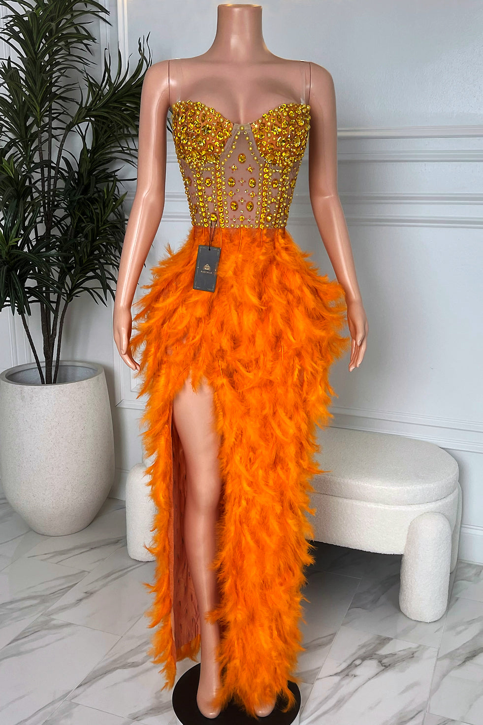 Amekana Solar Siren Feather Gown, orange feather maxi dress with yellow rhinestone corset bodice and high thigh slit, front view on mannequin.