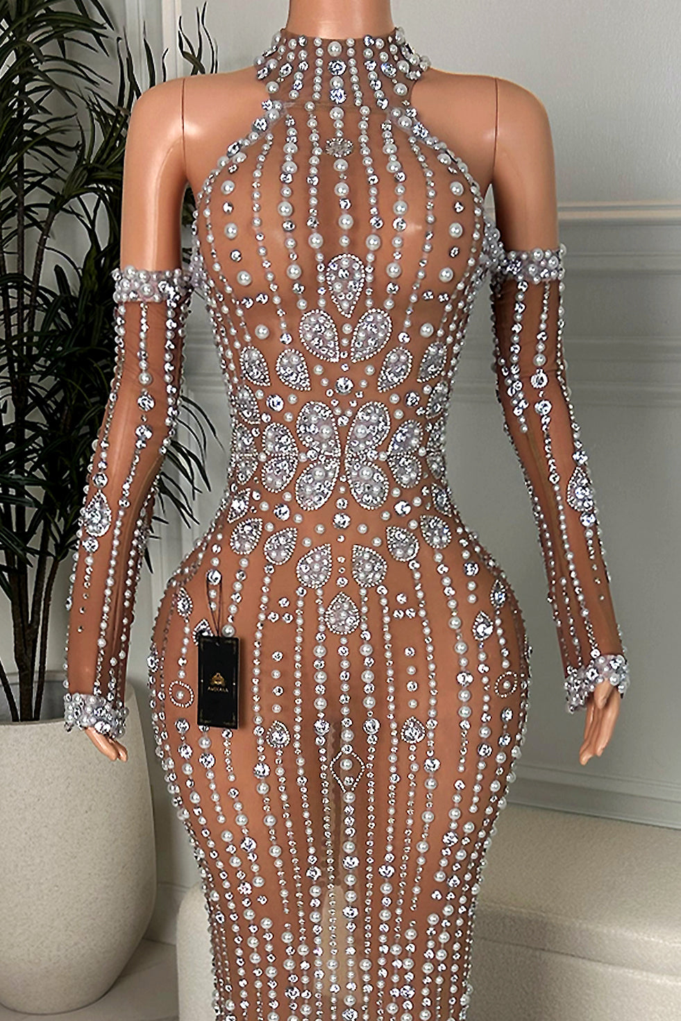 Close-up of brown nude illusion halter neckline with pearl and rhinestone embellishments and crystal floral center design, Amekana