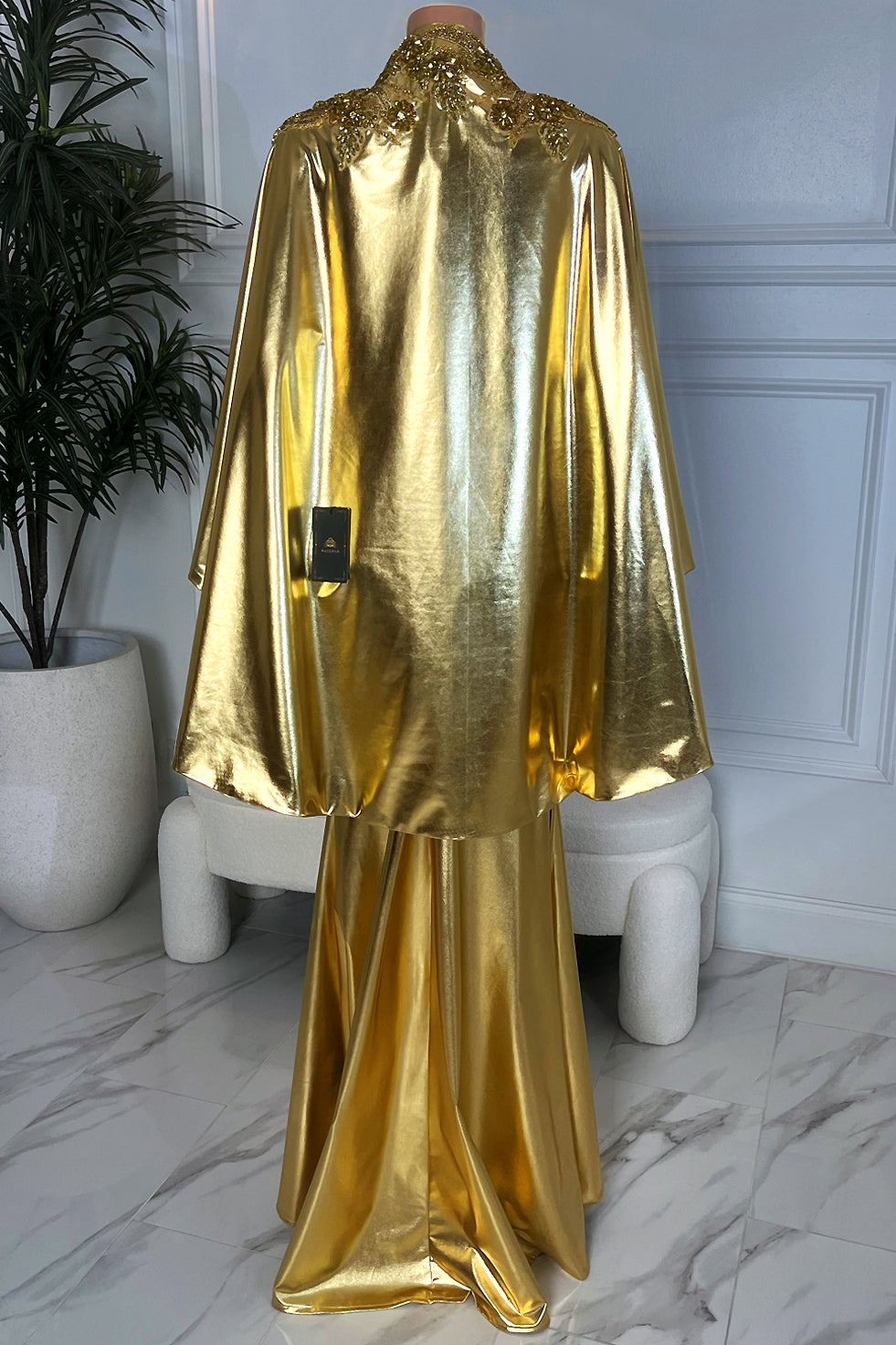 Metallic gold floor-length mermaid dress, fitted back view with high neck and smooth sculpted silhouette