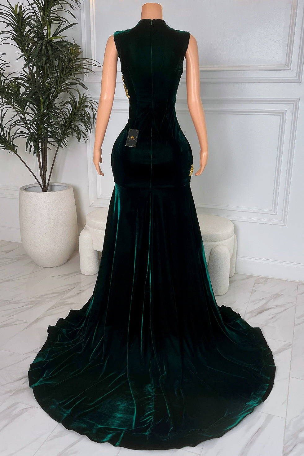 Back view of emerald green velvet sleeveless mermaid dress with floor-length train and smooth fitted silhouette