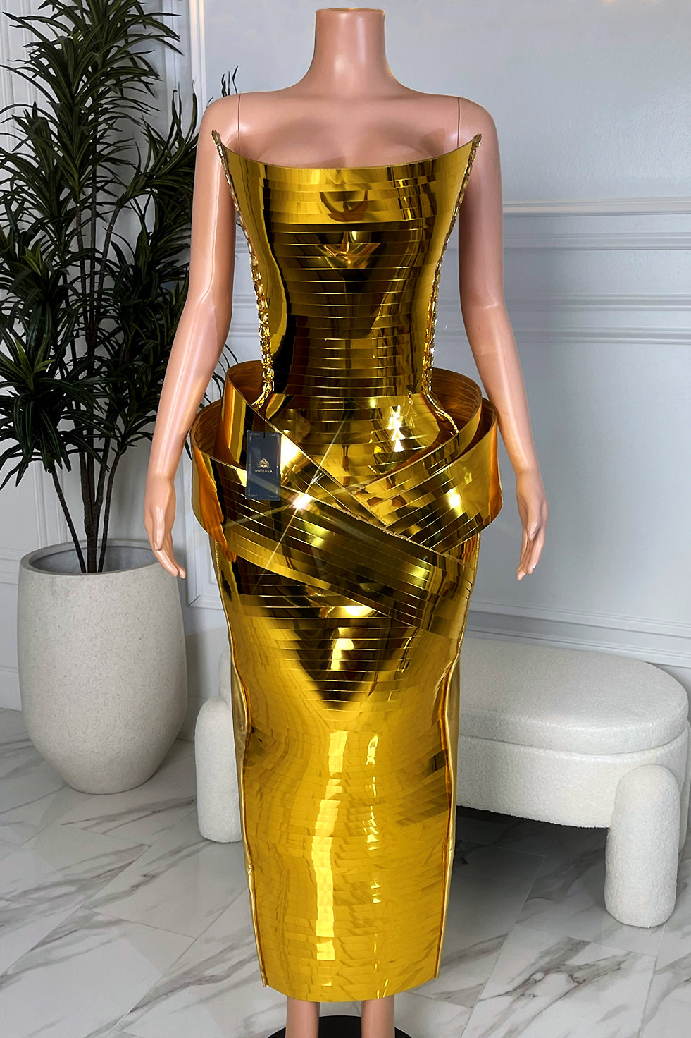 Model mannequin wearing Amekana Golden Empress Chrome Skirt Set, gold mirror corset with sculpted hip detail and midi skirt, front view.