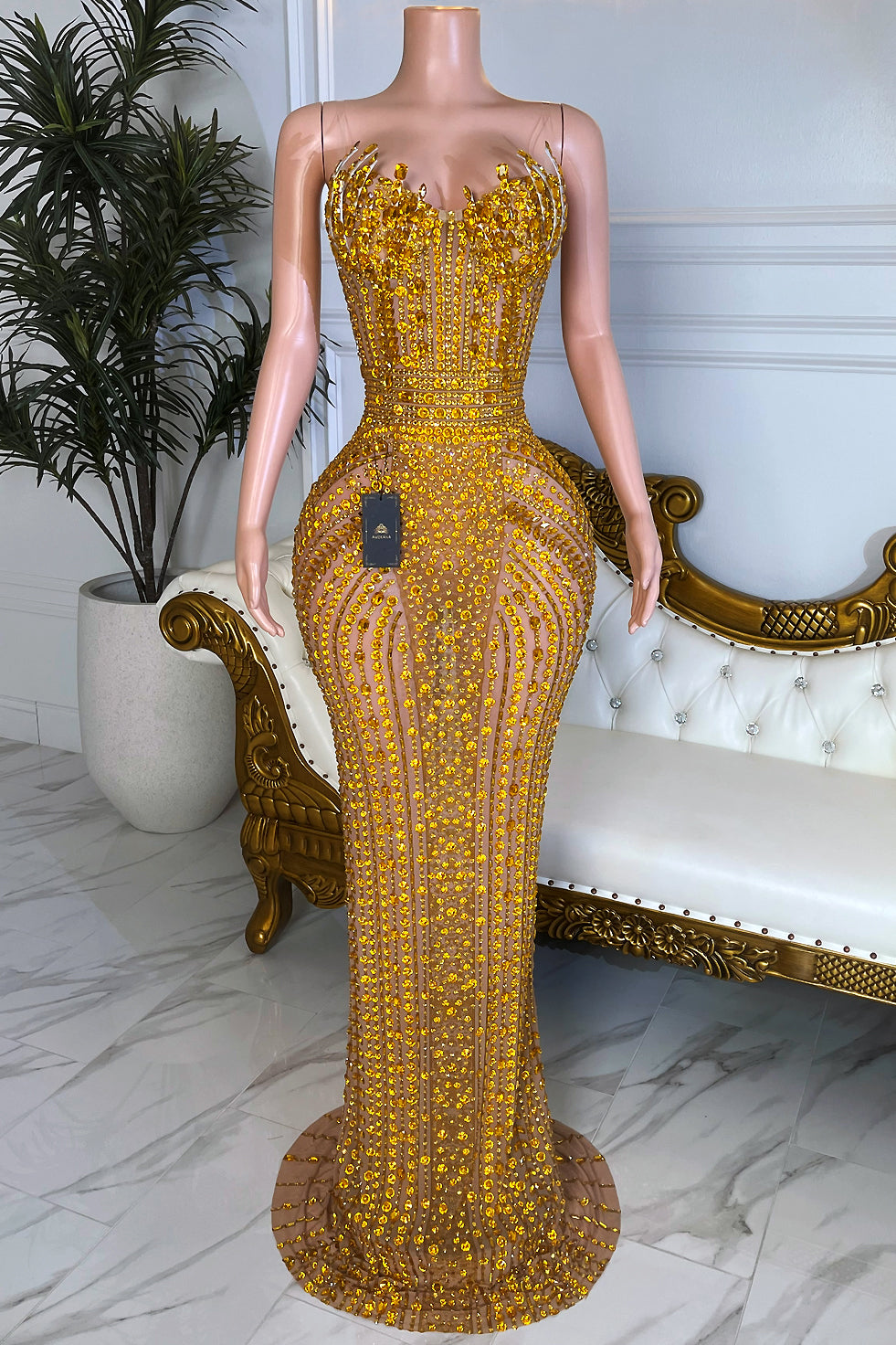 Gold rhinestone bodycon maxi dress on nude illusion mesh with strapless corset bodice and floor-length crystal detailing