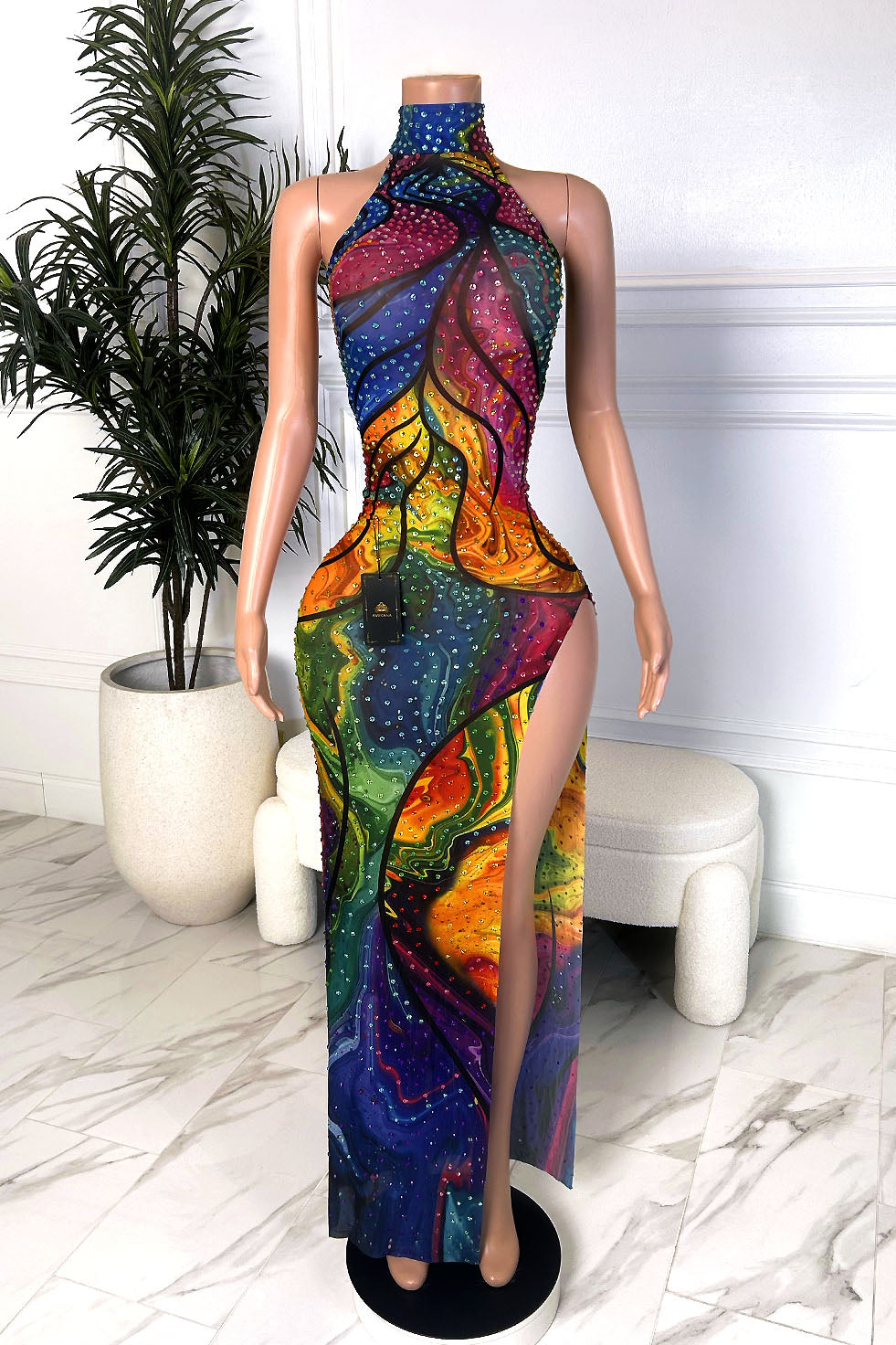 Front view of a multicolor halter gown with rhinestones, sheer side cutouts, and a thigh-high slit