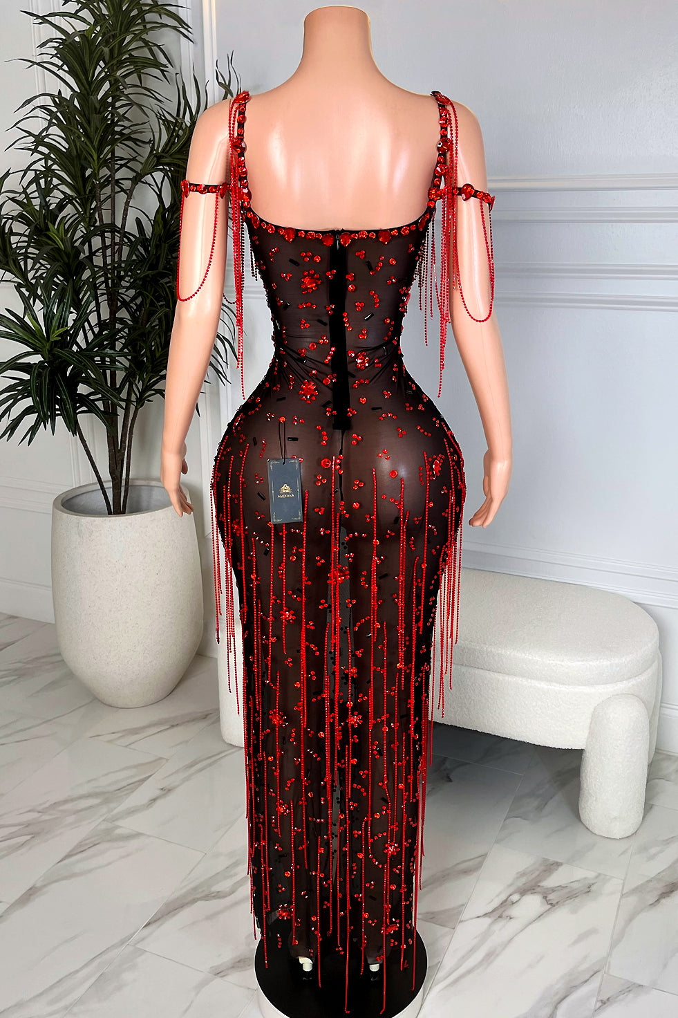 Back view of black mesh bodycon maxi dress with red crystal tassel fringe and beaded shoulder straps, evening party gown