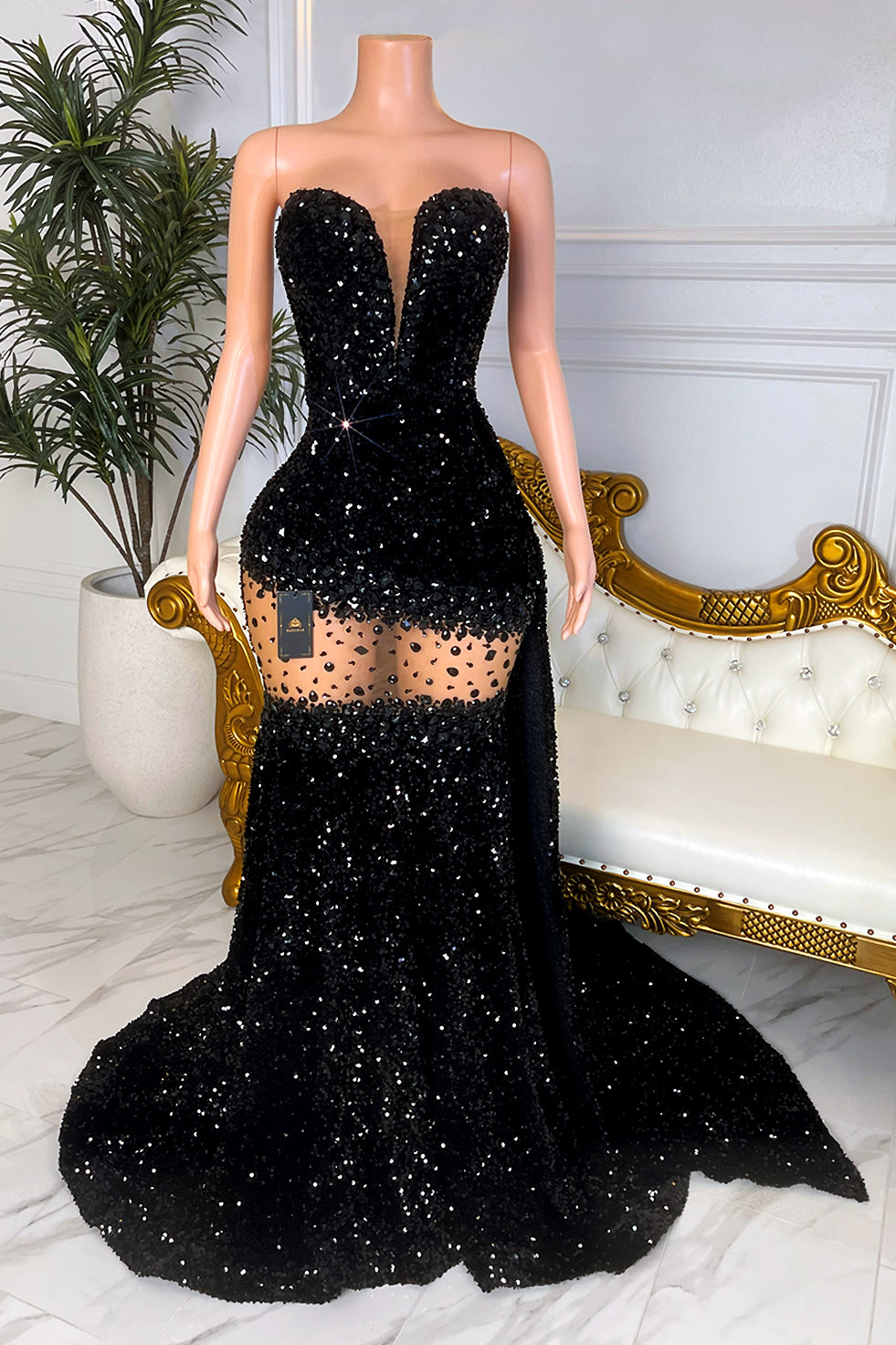 Strapless black sequin mermaid prom dress with deep plunge neckline and sheer thigh cutout”