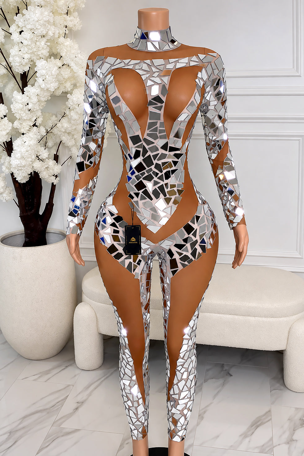 Amekana Nostalgia silver mirror jumpsuit featuring mosaic mirror embellishments, a plunging illusion neckline, long sleeves, and a fitted nude illusion silhouette.