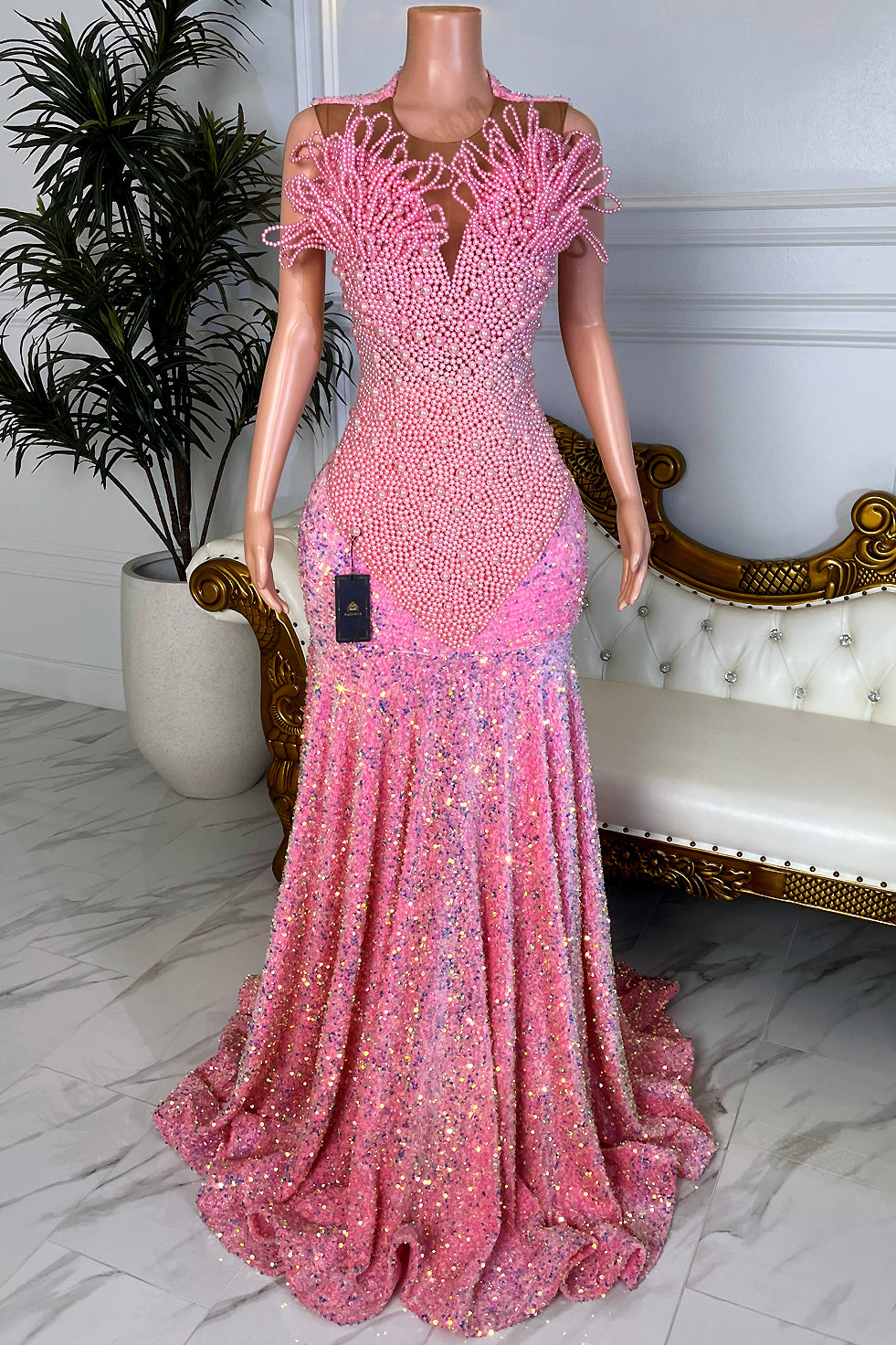 front of pearl-beaded pink bodice with an illusion plunge neckline and sculptural pearl shoulder detailing over a pink sequin mermaid gown