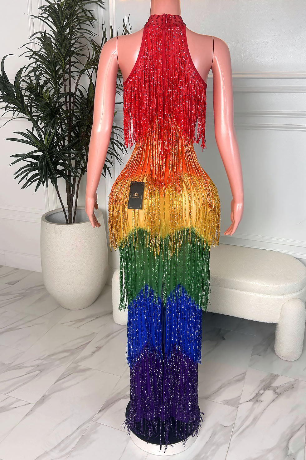 Back view of rainbow ombre halter maxi dress with crystal fringe tassels and vibrant color-block fade from red to purple