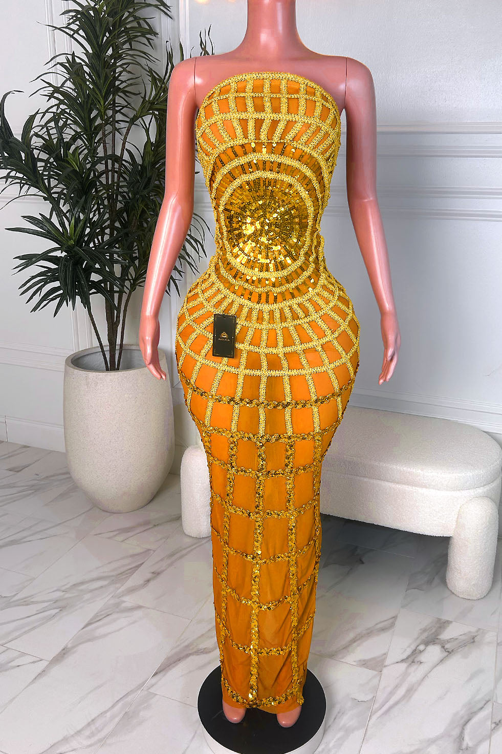 Front view of a red metallic one shoulder cutout mermaid gown with ruched wrap bodice and floor length train