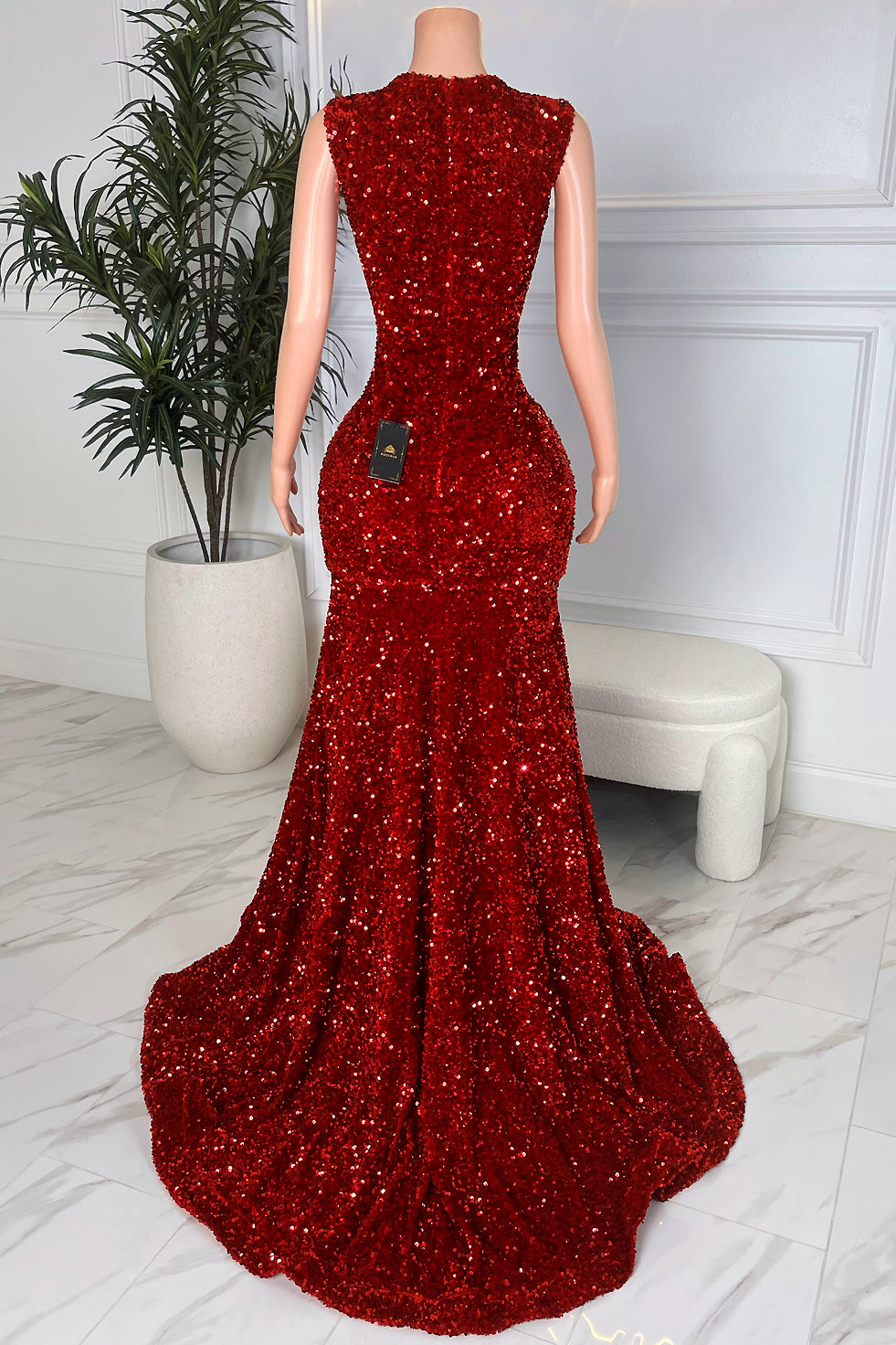 Back view of brown and silver sequin asymmetrical evening dress with draped sequin straps and sheer back