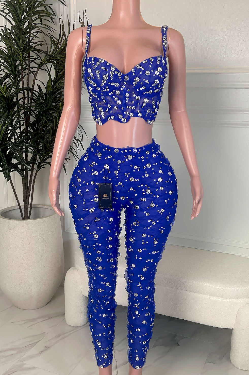 Royal blue rhinestone two piece set with corset style crop top and high waist pants, front view on mannequin.