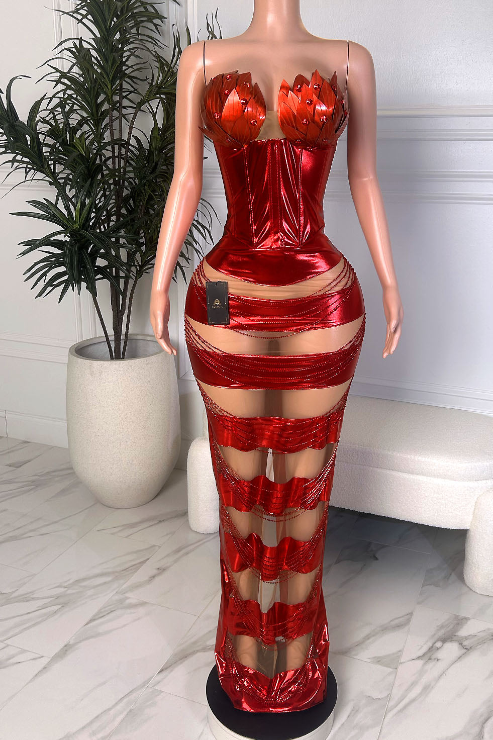 Front view of Scarlet Flame Gown, a metallic red corset maxi dress with floral bust detail and sheer paneled skirt
