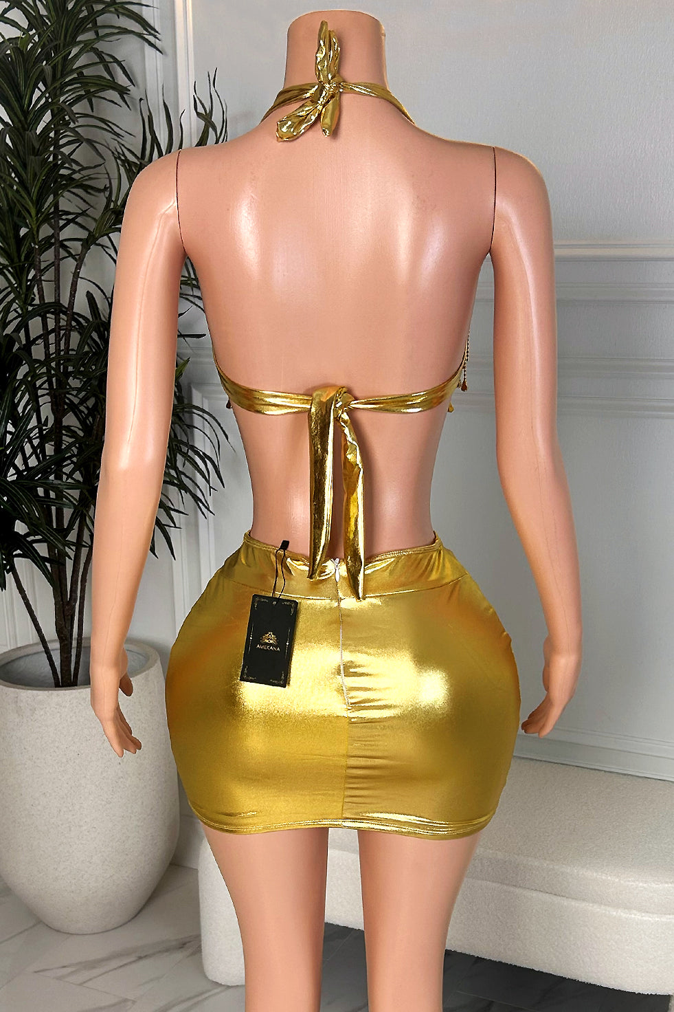 Sexy gold two piece mini skirt set with halter tie back and metallic mini skirt, back view