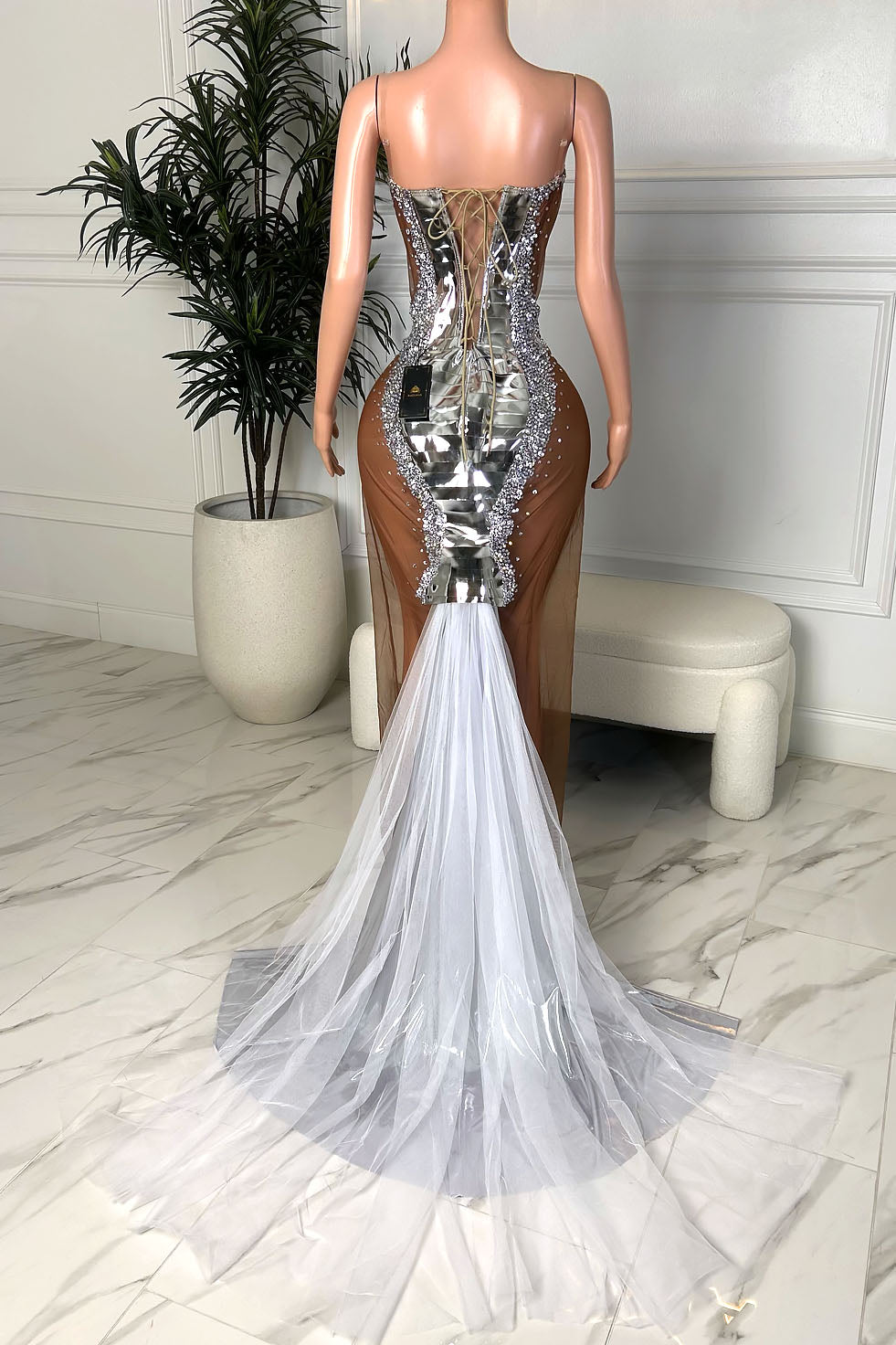 Front view of a silver crystal embellished gown with sweetheart neckline, mirrored center panel, nude illusion sides, and slim shoulder straps