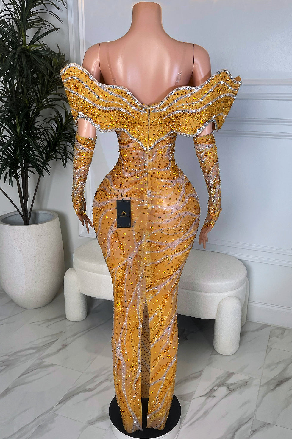 Back view of yellow rhinestone mesh gown with sculpted neckline and fitted column skirt.