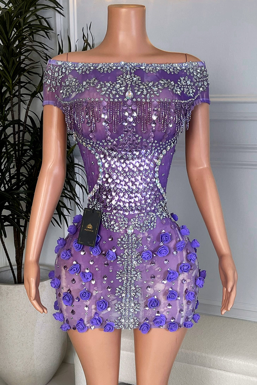 Front view of Violet Rose Empress Mini, purple off shoulder rhinestone mini dress with 3D roses on the skirt displayed on mannequin.