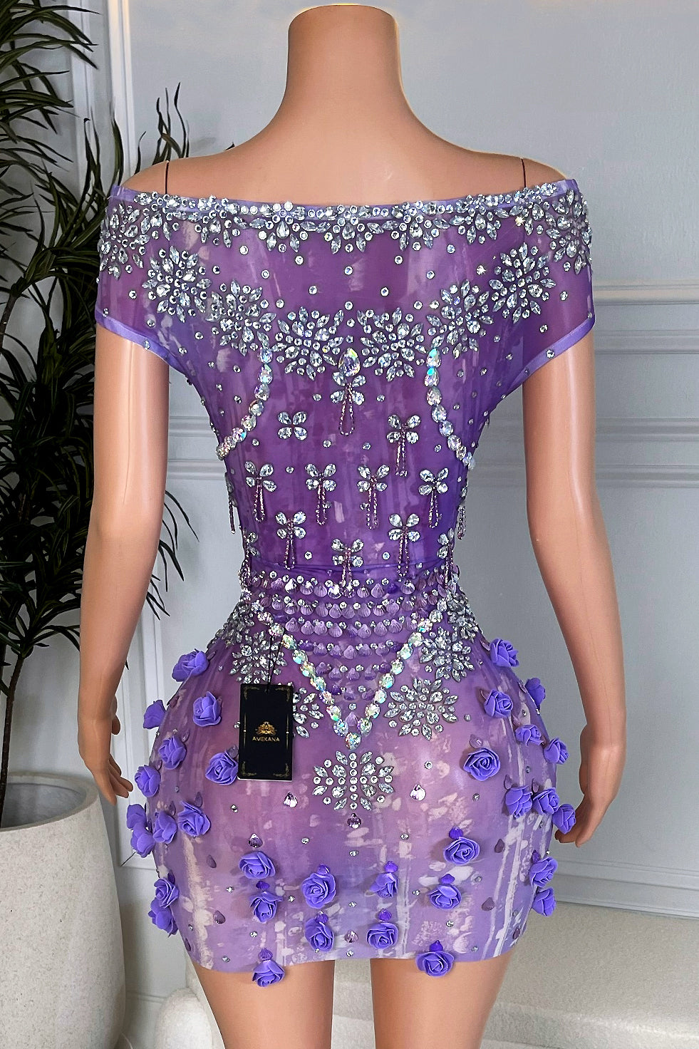 Back view of Violet Rose Empress Mini, lavender mesh mini dress with crystal embellishments and purple rose appliqués on the skirt.