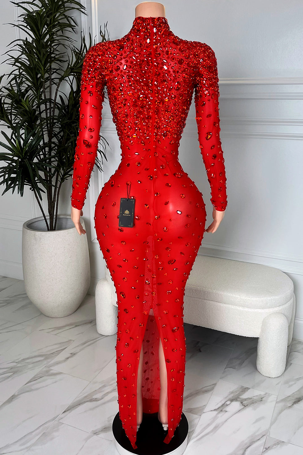 Red embellished rhinestone maxi gown with long sleeves, high neck, back zipper and back slit, rear view