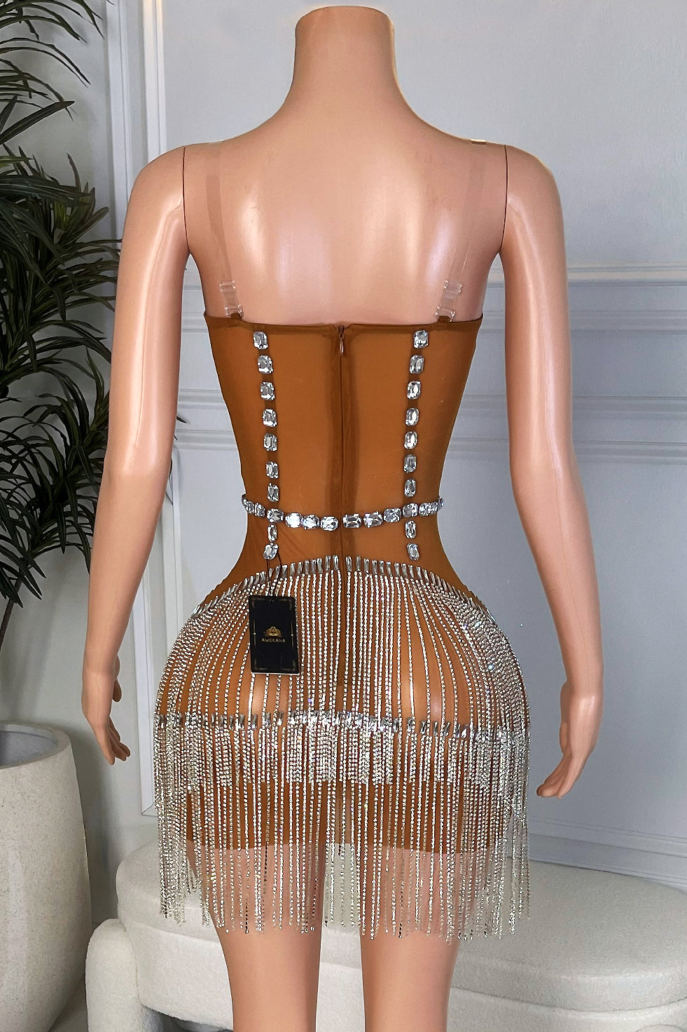 Back view of nude mini dress with zipper closure and full silver crystal tassel skirt, Amekana