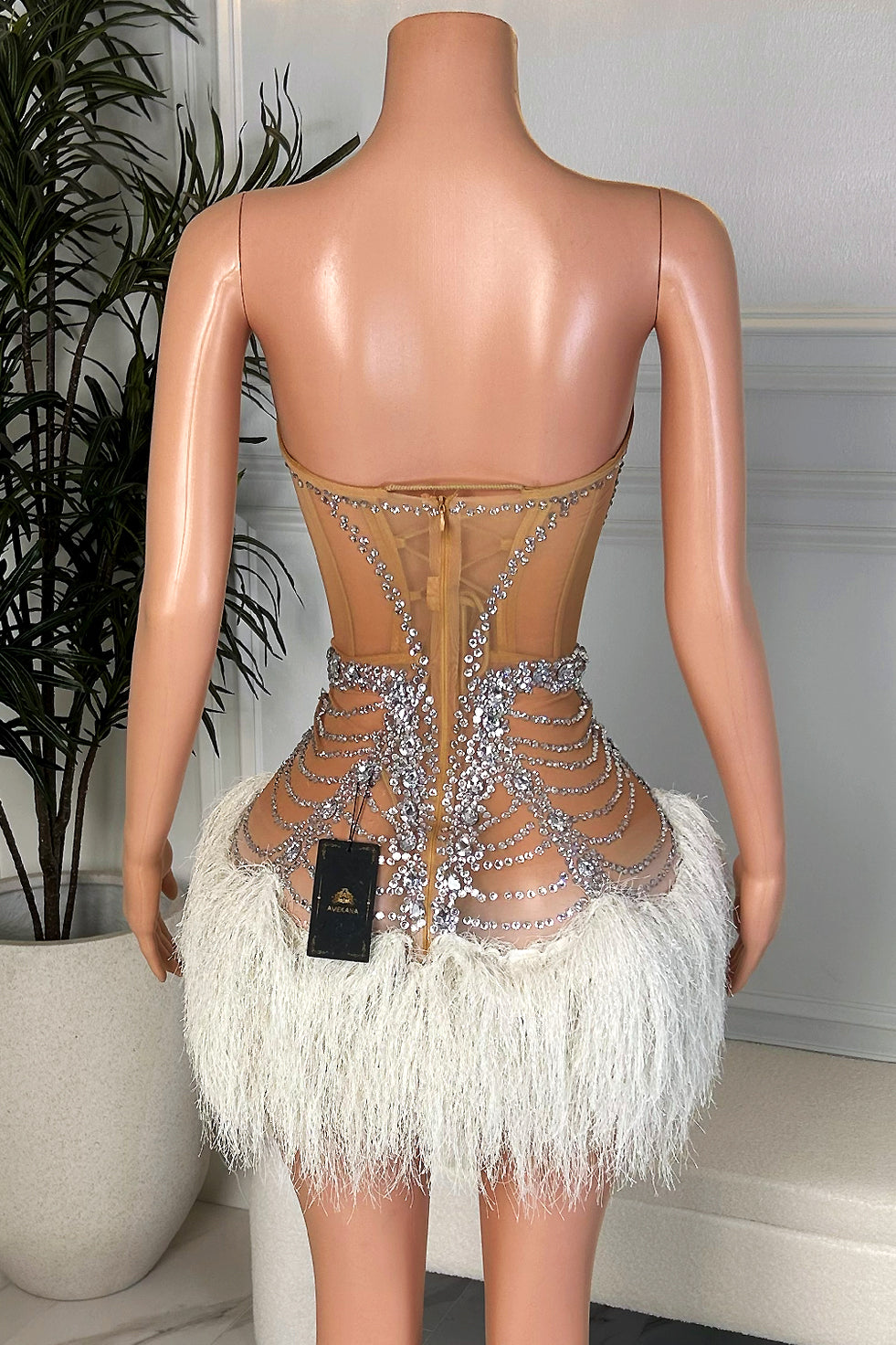 Back view of pink ruffle rhinestone nude illusion maxi dress with open-back design and layered sheer trim by Amekana.