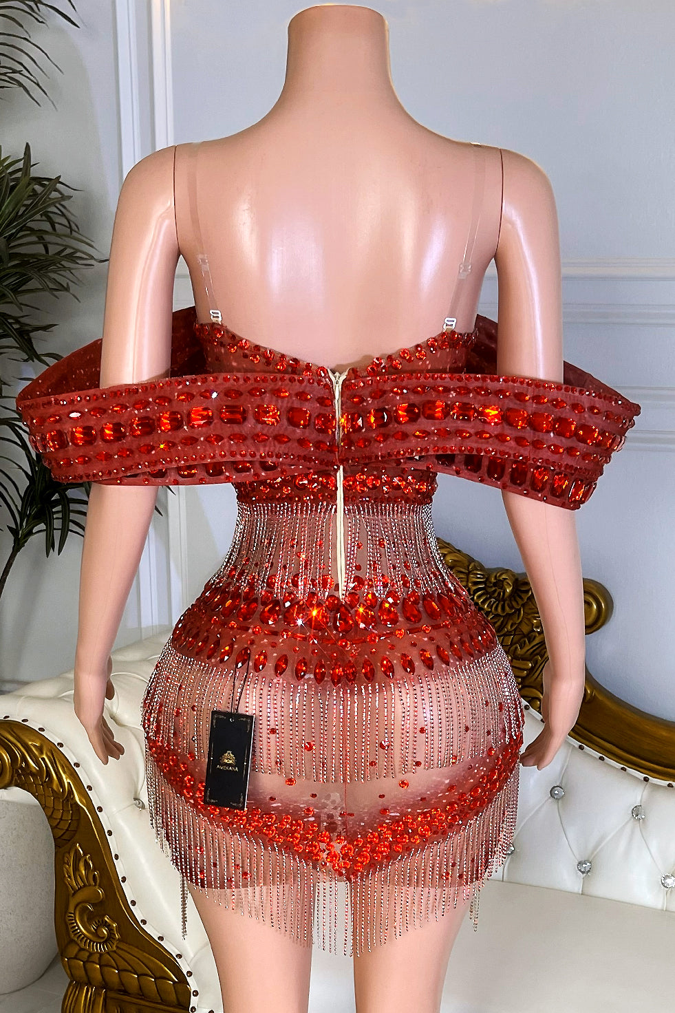 Back view of red rhinestone fringe mini dress featuring off-shoulder crystal neckline and hidden zipper closure