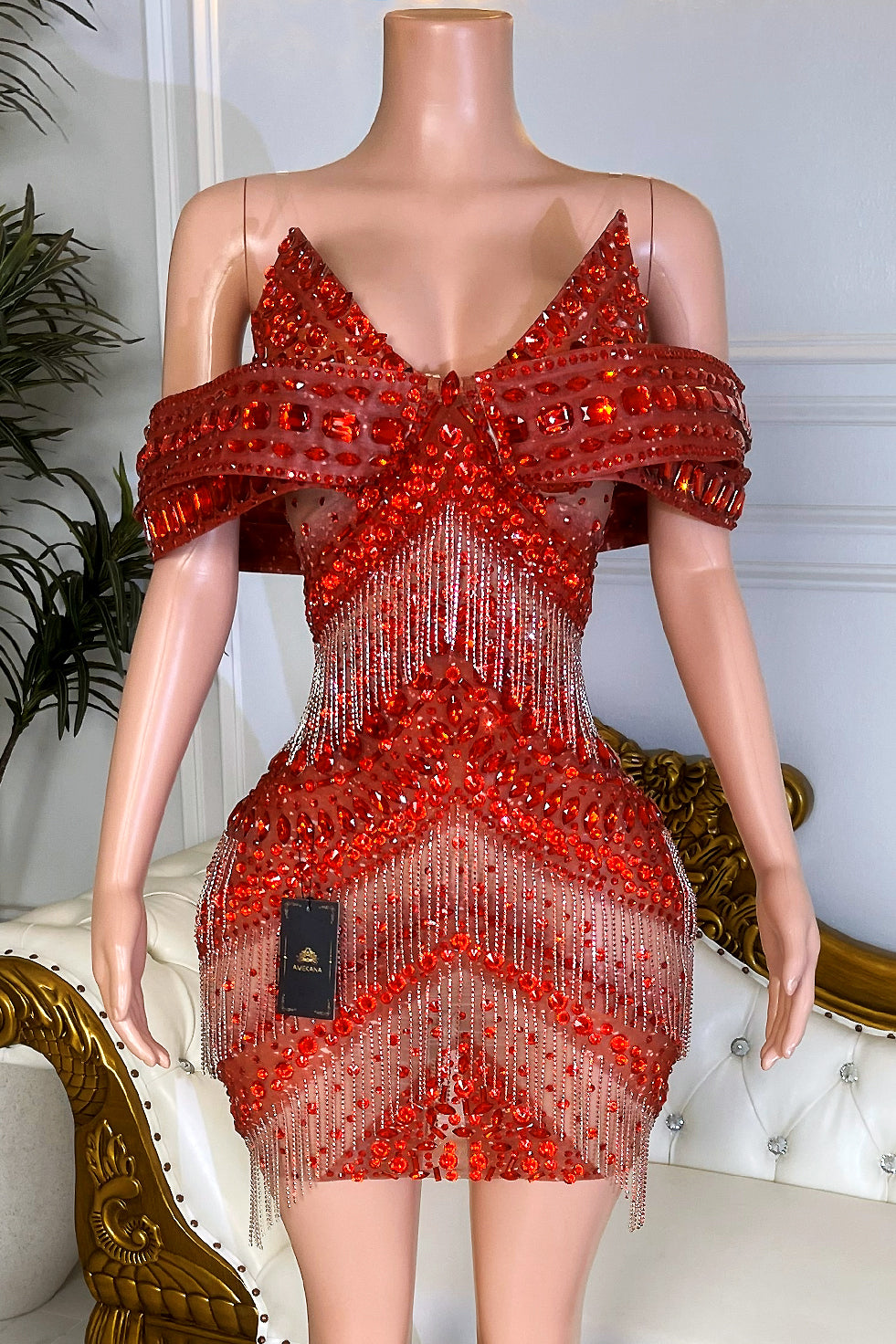 Red rhinestone tassel mini dress with off-shoulder crystal collar, nude illusion mesh, and sparkling fringe