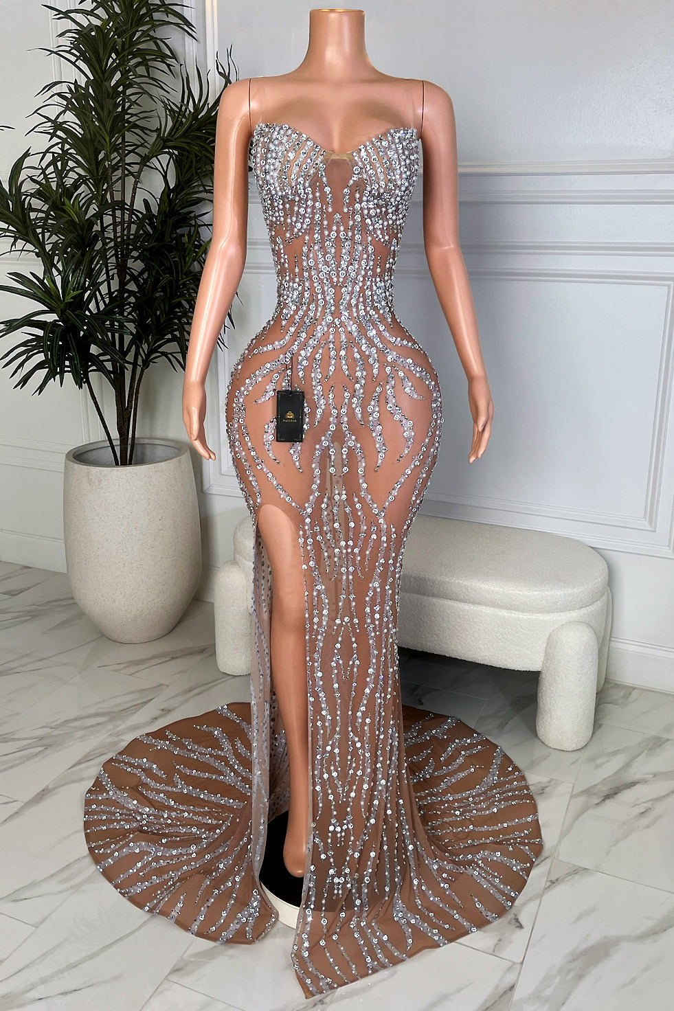 Nude illusion strapless maxi gown with silver rhinestone wand pattern, high side slit, and circular sweep train, Amekana