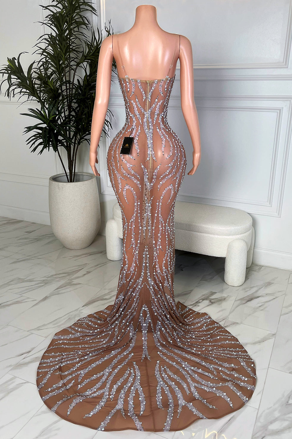 Back view of nude illusion silver rhinestone maxi dress with dramatic circular train and bodycon silhouette, Amekana