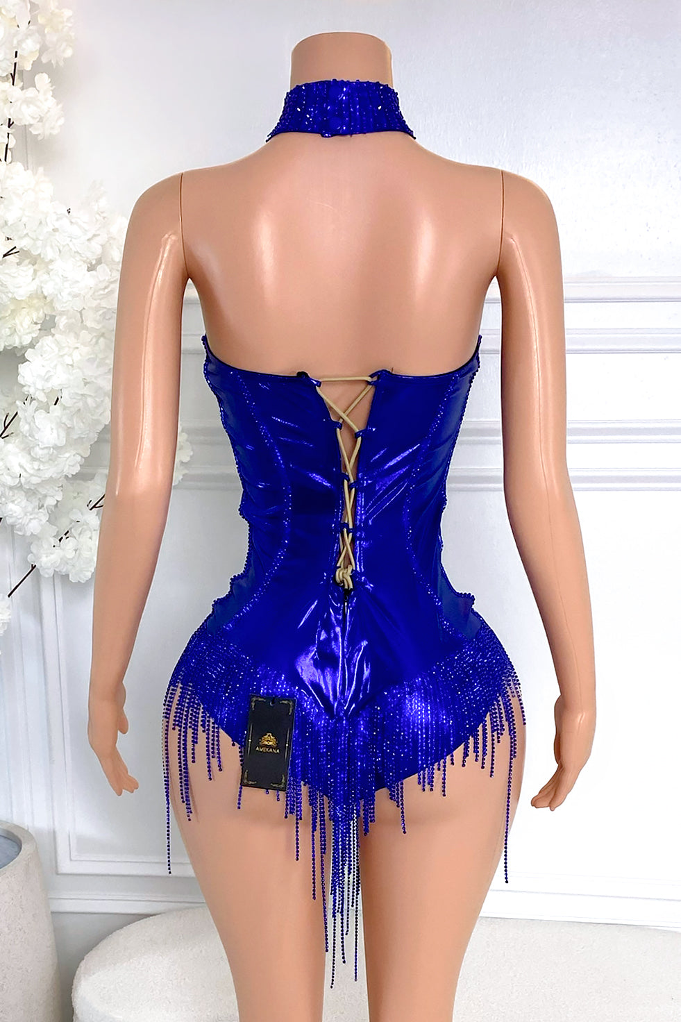 Back view of cobalt blue rhinestone fringe dress with lace-up corset closure, high-shine fabric, and beaded fringe detail