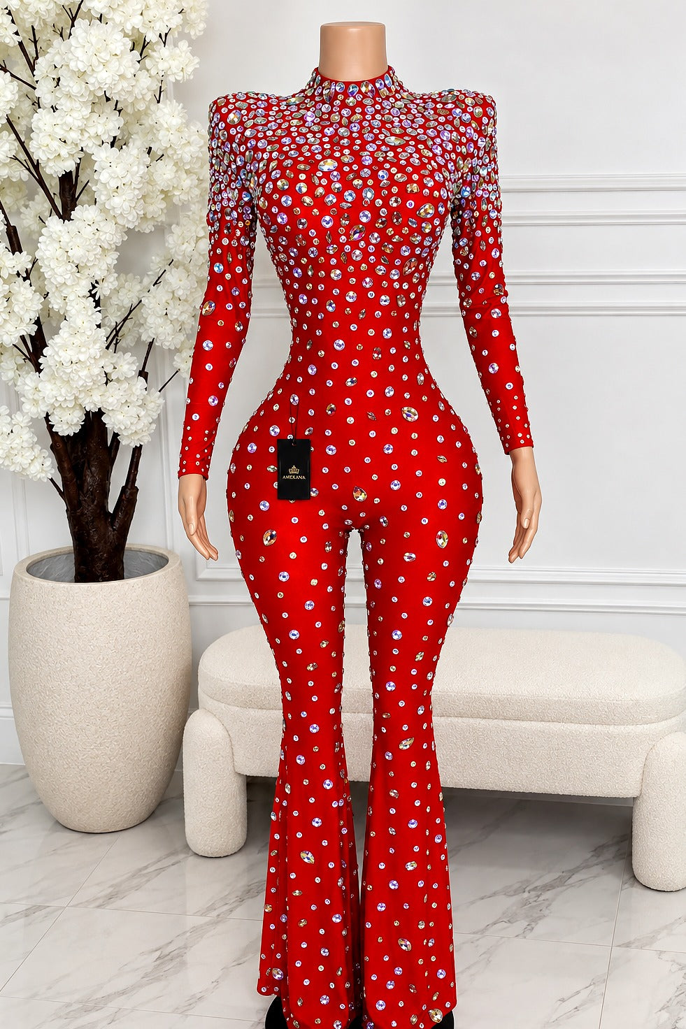 Front view of red high-neck long-sleeve jumpsuit featuring multicolor reflective rhinestones, defined waist and flared legs